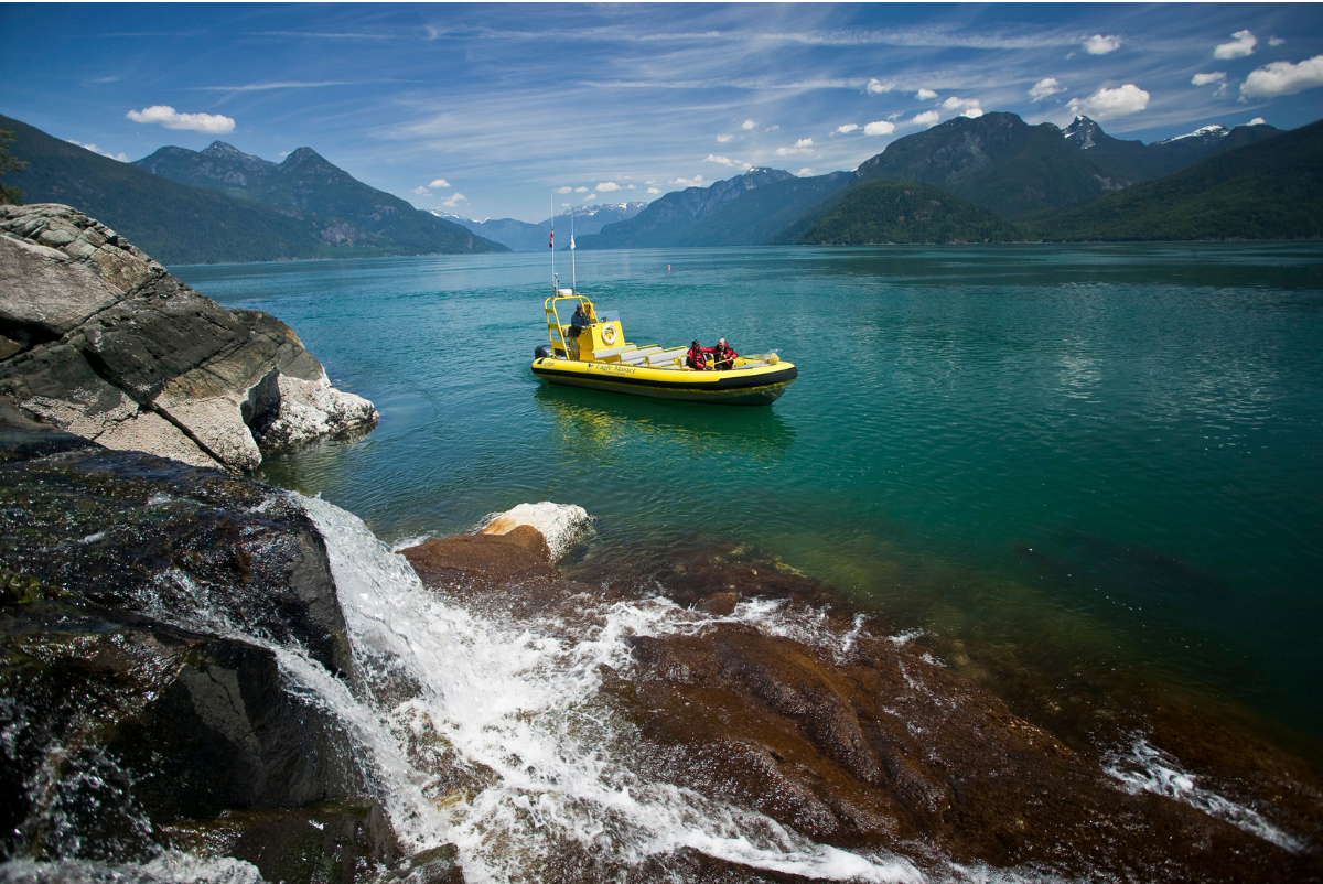 Eco-Adventure boat near waterfall in Bute Inlet