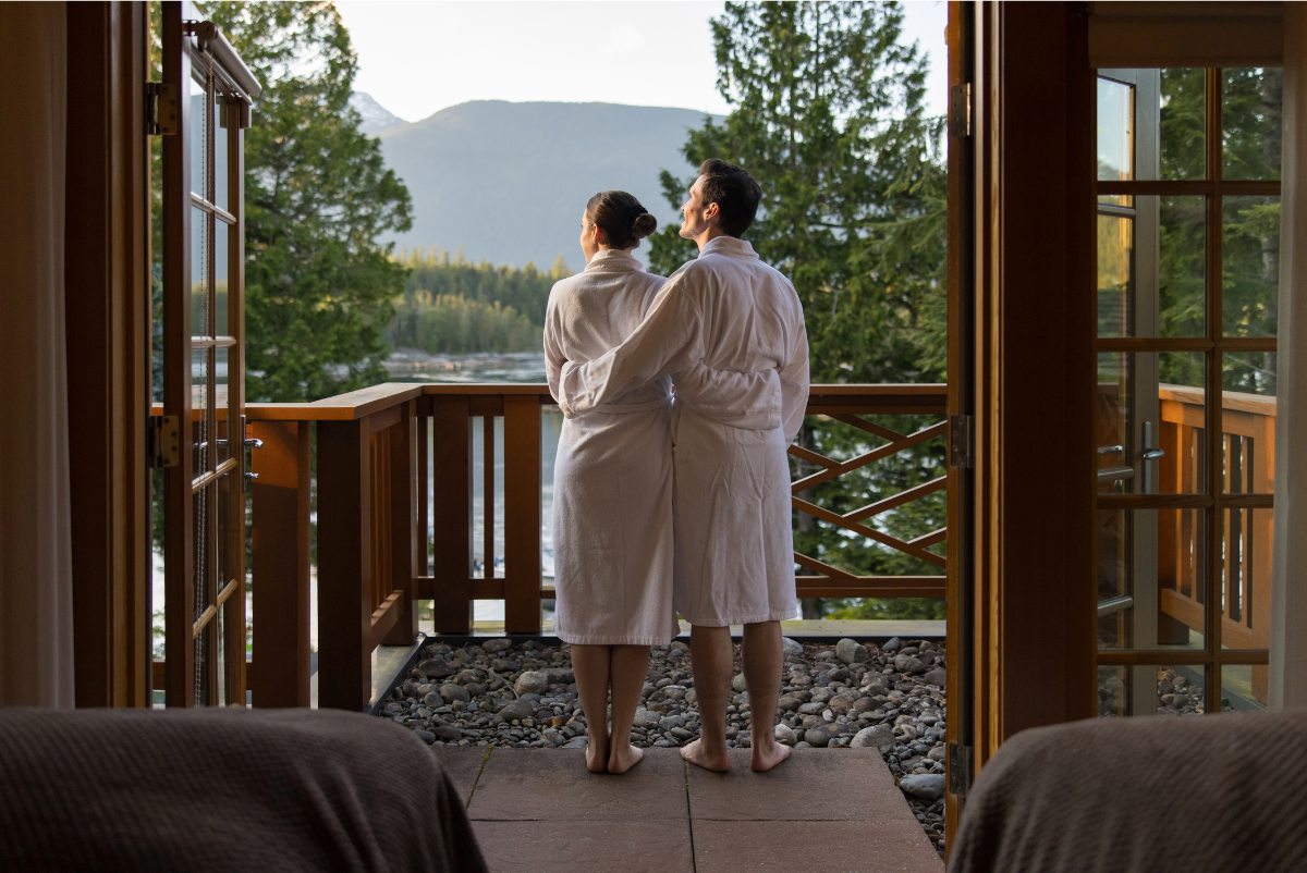 view of a couple standing outside a treatment room on the patio enjoying the view